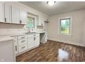 Bright kitchen featuring modern white cabinets, sleek black hardware, subway tile backsplash, and new countertops at 1032 Groff Ave, Indianapolis, IN 46222