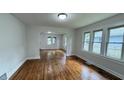 Bright living room features hardwood floors, white walls, and an abundance of natural light from three windows at 1032 Groff Ave, Indianapolis, IN 46222
