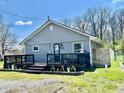 Exterior view of home showing gray siding, a black deck, and green lawn at 1117 Hendricks Ave, Shelbyville, IN 46176