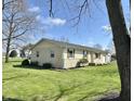 Well-kept single-level home showcasing a neatly landscaped yard and a classic, understated design at 1210 W Grant St, Thorntown, IN 46071