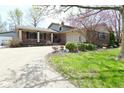 Inviting brick home with attached garage and a well-manicured front yard at 1229 Dallas Dr, Plainfield, IN 46168
