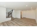 Spacious living room featuring hardwood-look floors, recessed lighting, and entry to staircase at 13349 Minden Dr, Fishers, IN 46037