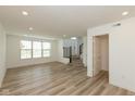 Open living room featuring recessed lighting, wood-look flooring, and natural light from large windows at 13349 Minden Dr, Fishers, IN 46037