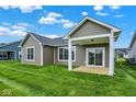 Well-maintained backyard of a home featuring a covered patio and lush green lawn at 19123 River Jordan Pass, Westfield, IN 46074