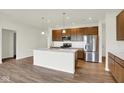 Modern kitchen with stainless steel appliances, a kitchen island, and pendant lighting at 19123 River Jordan Pass, Westfield, IN 46074