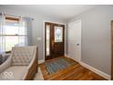 Welcoming foyer featuring hardwood floors and a stained-glass front door at 19702 Tomlinson Rd, Westfield, IN 46074