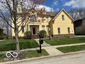 Welcoming home featuring a well-manicured lawn and a classic two-story design with a red front door at 1984 Telfair St, Carmel, IN 46032
