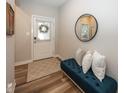 Cozy foyer with a comfortable bench, decorative mirror, and stylish flooring, creating a welcoming ambiance at 20133 Willenhall Way, Westfield, IN 46074