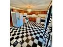 Charming kitchen featuring checkered flooring, wooden cabinetry, and modern appliances at 213 Harrell Dr, Edinburgh, IN 46124