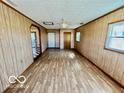 Spacious living room with wood paneling and durable laminate floors at 213 Harrell Dr, Edinburgh, IN 46124