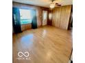 Bright living room featuring hardwood floors and natural light from large windows at 213 Harrell Dr, Edinburgh, IN 46124