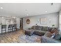 Open-concept living area with wood flooring, gray walls, and a comfortable sectional couch and open to the kitchen at 2936 W Calimanco Ln, Monrovia, IN 46157