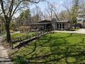 Beautiful home featuring a quaint porch, stone chimney, and a walkway leading to the well-manicured yard at 3311 Stella St, Greenwood, IN 46143