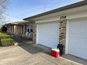 Attached two-car garage features a red cooler and white doors, complementing the home's exterior at 359 Anel Dr, Martinsville, IN 46151