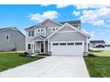 Inviting two-story home featuring stone accents, a two-car garage, and a well-maintained lawn at 3727 Thomas Jefferson Ct, Westfield, IN 46074
