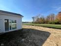 Scenic backyard view of a pond and green space, accessible via sliding glass doors at 3847 Thomas Jefferson Ct, Westfield, IN 46074