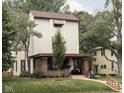 Charming two-story home with a brick-accented porch, awning-covered windows, and mature trees at 40 N Ritter Ave, Indianapolis, IN 46219