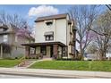 Charming two-story home with a brick-accented porch, awning-covered windows, and well-maintained lawn at 40 N Ritter Ave, Indianapolis, IN 46219