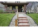 Inviting front porch with brick pillars and steps leading to the entrance, surrounded by a lush lawn at 40 N Ritter Ave, Indianapolis, IN 46219