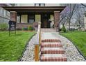 Close up of home's front yard with brick steps and lovely landscaping at 40 N Ritter Ave, Indianapolis, IN 46219