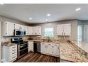 Well-lit kitchen featuring white cabinets, stainless steel appliances, and granite countertops at 416 Concord Way, Greenwood, IN 46142