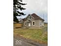 Charming two-story home featuring neutral siding, a brown roof, and a well-maintained front yard at 422 Hege Ave, Columbus, IN 47201