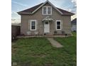 Attractive home with a cozy front yard, traditional shutters, and a bright white front door at 422 Hege Ave, Columbus, IN 47201