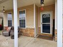 Cozy front porch featuring two comfortable chairs, brick accents, and an inviting entrance at 4383 Round Lake Bnd, Indianapolis, IN 46234