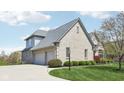 Side view of a two-story brick home with a gray roof and attached two-car garage at 476 Sapphire Dr, Carmel, IN 46032