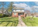 Attractive home featuring a well-manicured lawn, sidewalk, and mature trees in a residential neighborhood at 504 S Lebanon St, Lebanon, IN 46052