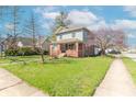 Lovely home showcasing a green lawn, mature trees, and a sidewalk in a quiet residential area at 504 S Lebanon St, Lebanon, IN 46052