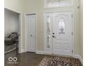 Inviting foyer with hardwood floors, decorative front door, and view into a sitting room, creating a warm and welcoming entrance at 537 Weyworth Pl, Greenwood, IN 46142