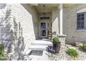 Charming front porch featuring neutral brick, a seating area, and decorative greenery enhancing the inviting entrance at 537 Weyworth Pl, Greenwood, IN 46142