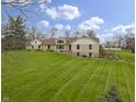 Inviting exterior featuring stone, siding, manicured lawn, and flower beds on a landscaped lot at 5455 S 800 E, Zionsville, IN 46077