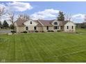 Charming stone and siding home featuring a well manicured lawn and inviting front entrance at 5455 S 800 E, Zionsville, IN 46077