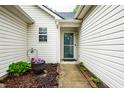 Welcoming front entrance with a decorative flower pot and manicured landscaping at 558 Prince Dr, Greenwood, IN 46142