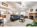 Cozy living room featuring a fireplace, ceiling fan, and plush seating at 558 Prince Dr, Greenwood, IN 46142