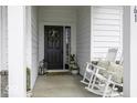 Inviting front porch with rocking chairs, decorative wreath, and charming decor perfect for relaxation and curb appeal at 561 Riviera Pl, Greenwood, IN 46143