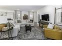 Spacious living room featuring a comfortable sectional sofa, modern decor, and plenty of natural light for a cozy atmosphere at 561 Riviera Pl, Greenwood, IN 46143