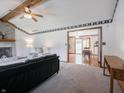 Cozy living room with a brick fireplace, beamed ceiling, and natural light at 575 Crestpoint Ln, Plainfield, IN 46168