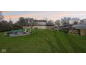 Spacious backyard with a fire pit area, surrounded by a wooden fence at 5831 Bar Del W Dr, Indianapolis, IN 46221
