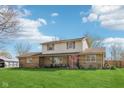 Charming two-story home featuring a covered front porch and a spacious green lawn at 5831 Bar Del W Dr, Indianapolis, IN 46221