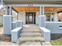 Inviting front porch with wood ceiling, supported by sturdy pillars and concrete steps at 609 E Southern Ave, Indianapolis, IN 46203