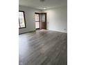 Bright living room showcasing newly installed laminate flooring, fresh paint, and a welcoming front door at 613 Rahkewood Dr, Indianapolis, IN 46217