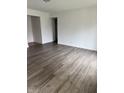 A spacious and bright living room with stylish laminate flooring and fresh white walls at 613 Rahkewood Dr, Indianapolis, IN 46217