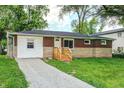 Charming single-story home featuring brick facade, a well-maintained lawn and a gravel driveway at 6189 Vigo Dr, Clayton, IN 46118