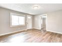 A bright living room featuring wood-look flooring, neutral paint, and natural light through a large window at 6189 Vigo Dr, Clayton, IN 46118