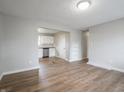 Spacious living room with new laminate floors with a doorway leading into the kitchen at 6189 Vigo Dr, Clayton, IN 46118