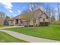 Charming brick home with a well-maintained lawn and lovely landscaping creating great curb appeal at 6841 W Glory Maple Dr, McCordsville, IN 46055