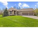 Attractive brick home boasts a spacious three-car garage and a lush green lawn at 6841 W Glory Maple Dr, McCordsville, IN 46055